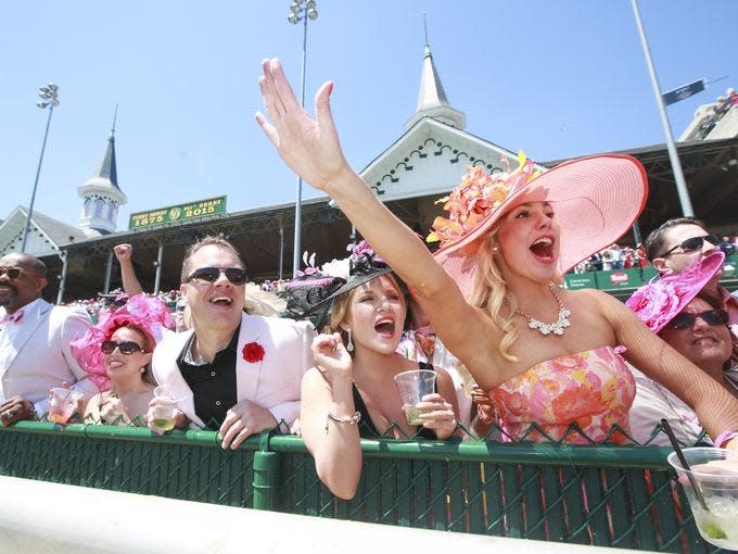 Heather Merten, from right, Laura Cessna, Chuck Marksbury and Savannah Moroz cheer during the finish of The La Troienne race at the Kentucky Oaks on Friday. May 1, 2015  Alton Strupp/The Courier-Journal