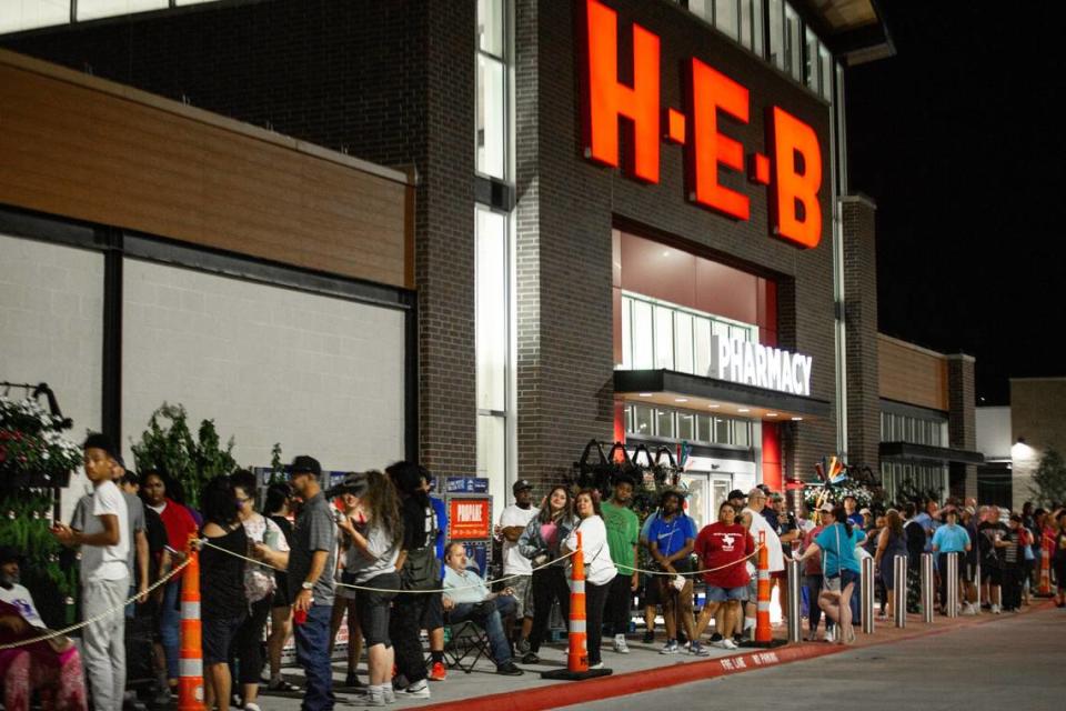 Shoppers stand in a line for the store to open during the grand opening of HEB on Wednesday, June 26 in Mansfield. More than 1,000 people lined up for the event.