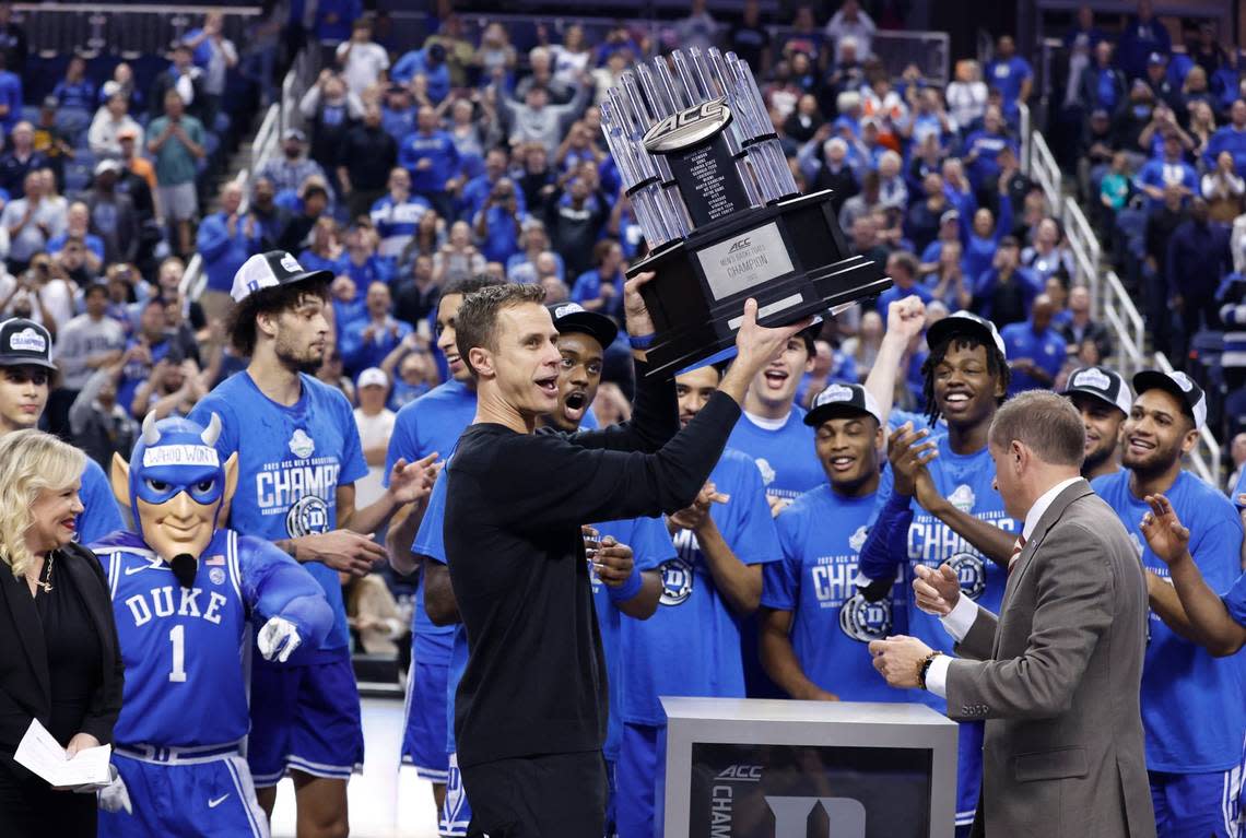 Duke head coach Jon Scheyer holds up the championship trophy after Duke’s 59-49 victory over Virginia to win the ACC Men’s Basketball Tournament in Greensboro, N.C., Saturday, March 11, 2023.