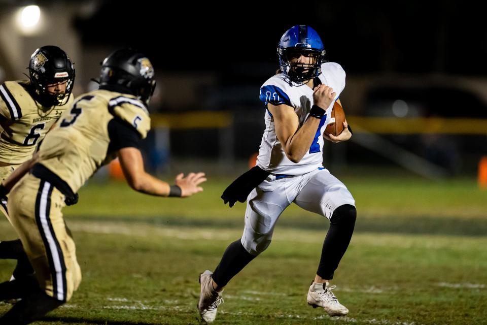 Bartram Trail quarterback Riley Trujillo (11) scrambles with the ball during the first half against Buchholz.