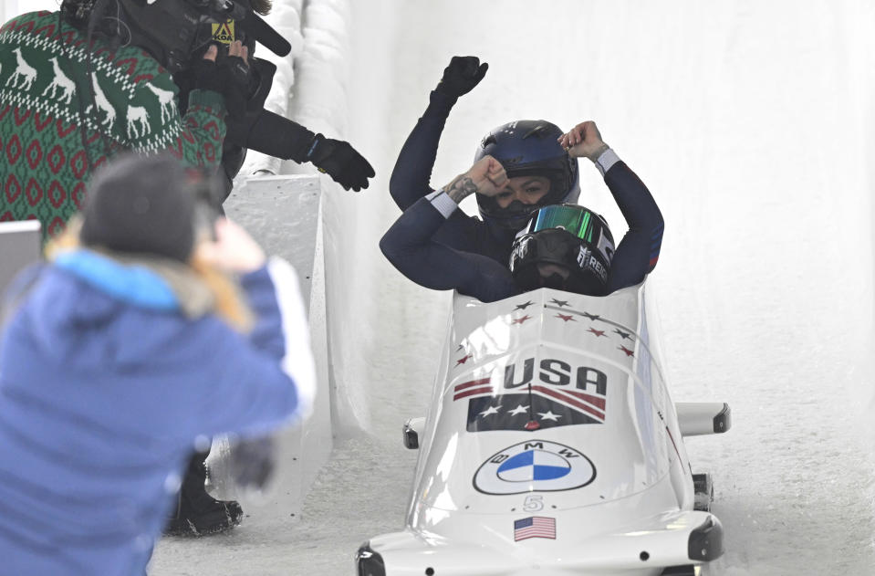 FILE - Kaillie Humphries and Kaysha Love of The United States, celebrate a first place finish after the second run of the women's bobsled World Cup race on Sunday, Dec. 18, 2022, in Lake Placid, N.Y. Love is moving from push athlete to driver for the U.S. and will make her World Cup debut as a pilot next month with hopes of moving closer to a spot in the 2026 Olympics.(AP Photo/Hans Pennink, File)