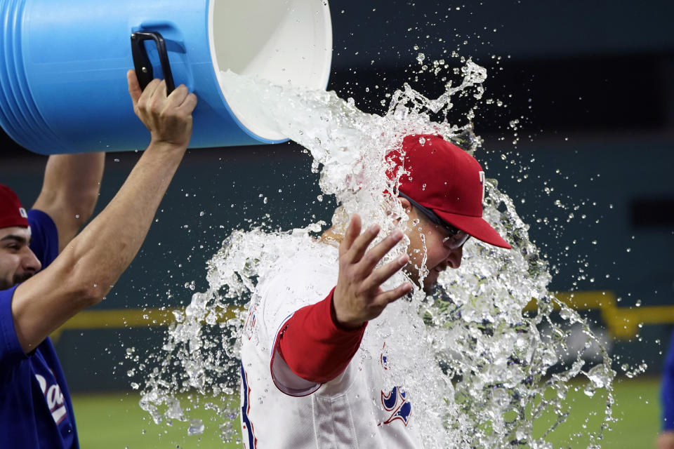 Texas Rangers starting pitcher Dane Dunning, right, get doused by Martin Perez after the team's baseball game against the Detroit Tigers in Arlington, Texas, Wednesday, June 28, 2023. (AP Photo/LM Otero)