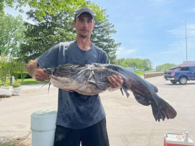 Lloyd Tanner holds the Michigan state-record flathead catfish that he caught in the St. Joe River on May 29, 2022.