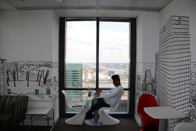 A man uses a laptop in the Level39 FinTech hub based in the One Canada Square tower of the Canary Wharf district of London