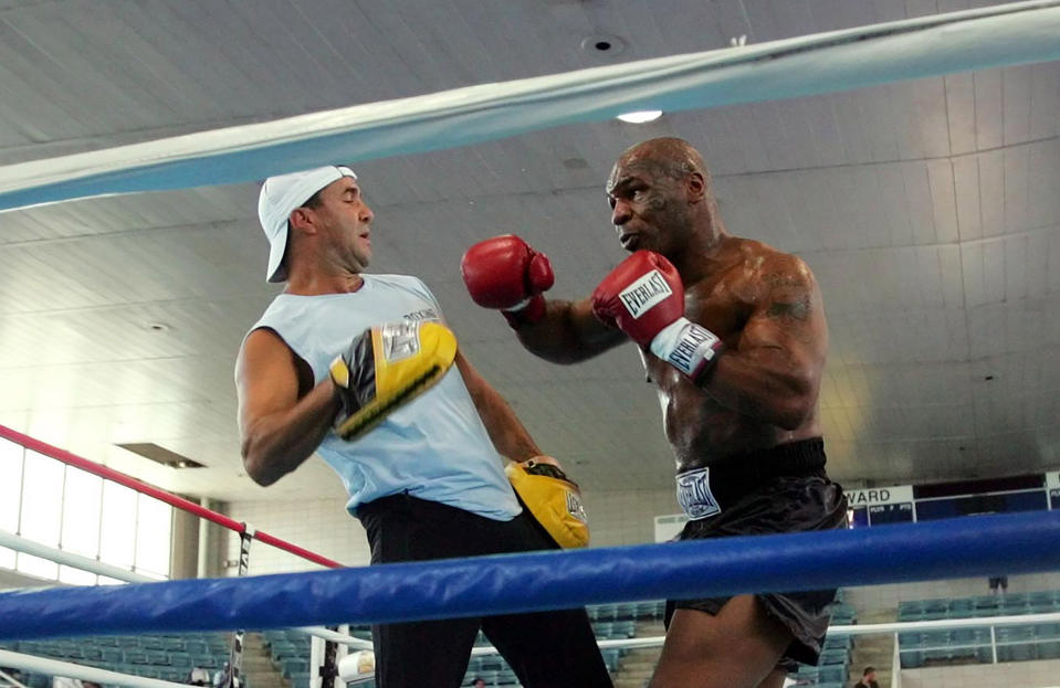 FILE - In this June 7, 2005, file photo, former Heavyweight Champion Mike Tyson, right, spars with his trainer Jeff Fenech in the ring at Burr Gymnasium in Washington. Fenech will undergo surgery in Bangkok to repair an infected heart valve. Australian boxer Jack Brubaker tells The Associated Press his mentor is hospitalized with a bad lung infection but remains conscious. (AP Photo/Pablo Martinez Monsivais, File)