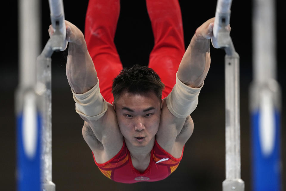 China's Sun Wei performs on the parallel bars during the men's artistic gymnastic qualifications at the 2020 Summer Olympics, Saturday, July 24, 2021, in Tokyo. (AP Photo/Gregory Bull)