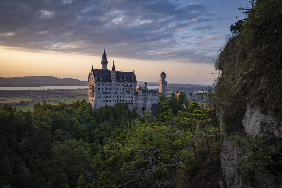 A view of the Neuschwanstein castle, in Schwangau, Germany, Thursday, June 15, 2023. Authorities say an American man has been arrested in Germany after allegedly assaulting two tourists he met near Neuschwanstein castle. The attack, which occurred on Wednesday, left one of the women dead. Police said Thursday that the 30-year-old man met the two women on a hiking path and lured them onto a trail. They said the man then “physically attacked” the younger woman. (Frank Rumpenhorst/dpa via AP)