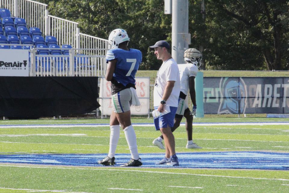UWF football quarterback Peewee Jarrett (7) and head coach Kaleb Nobles talk during the Argos' practice on Wednesday, Sept. 6, 2023, in preparation for UWF's Week 2 game at McKendree University.