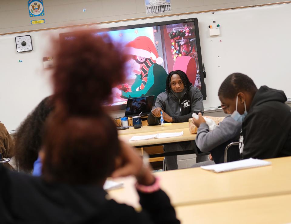 Millwood Arts Academy teacher Chevis Smith talks to students in his classroom Dec. 16.