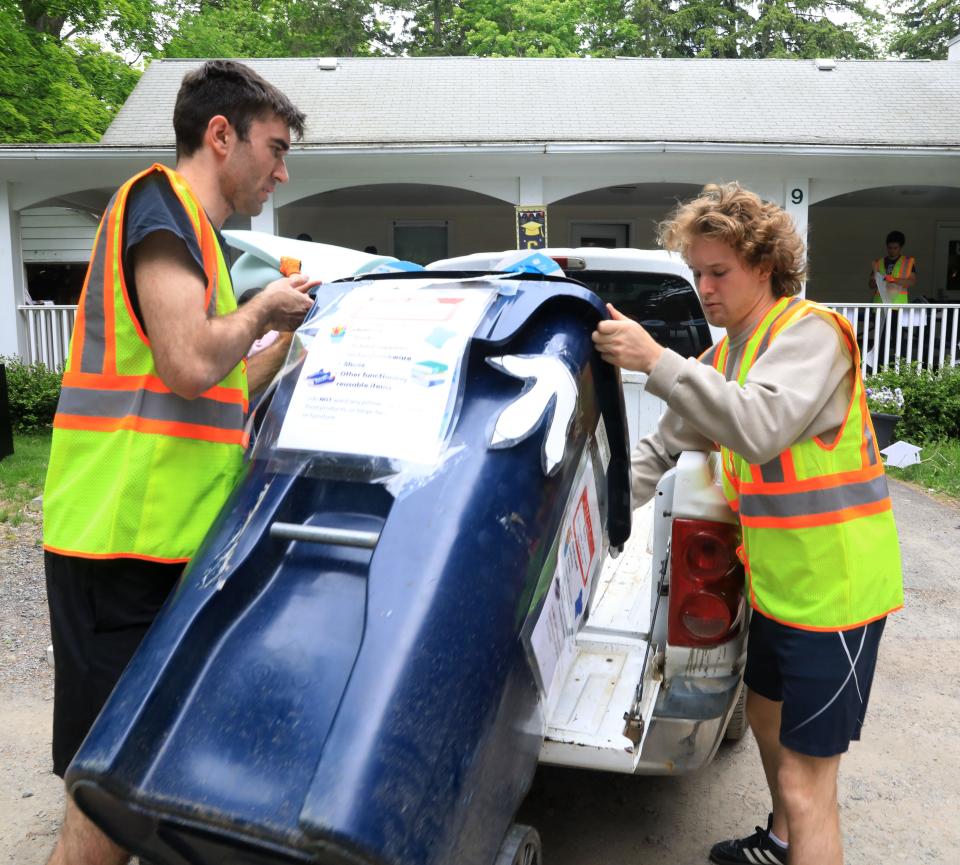 Bard College incoming seniors, from left, Quincy Ross and Jack Loud unload donation bins from around campus for Bard's Free-Use Store on May 26, 2022. 