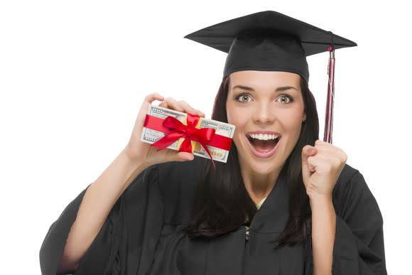 Woman in graduation attire holding giftwrapped cash