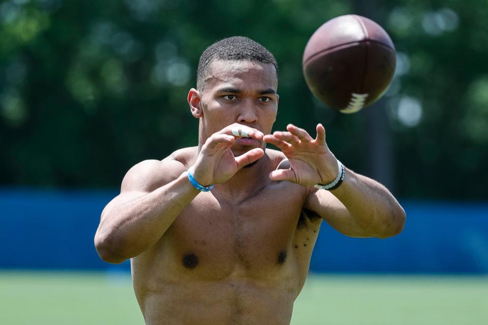 Detroit Lions wide receiver Amon-Ra St. Brown (14) practices during OTAs at Detroit Lions headquarters in Allen Park on Thursday, June 1, 2023.