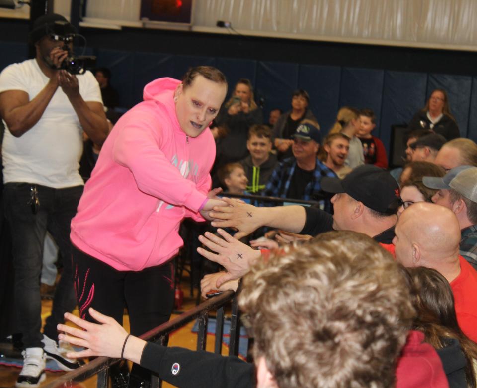 Hornell native Kayda Cyn interacts with fans on the way to the ring for a bout with Darren Crowe during Xcite Wrestling's first-ever event in Hornell Saturday, March 30, 2024 at the YMCA.