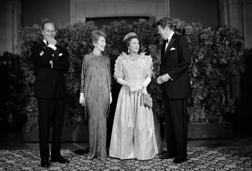 President Ronald Reagan and first lady Nancy Reagan pose for photographers with Queen Elizabeth II and Prince Philip at a formal state dinner, March 3, 1983, at the M.H. de Young Museum in San Francisco's Golden Gate Park. (AP Photo/Ed Reinke)