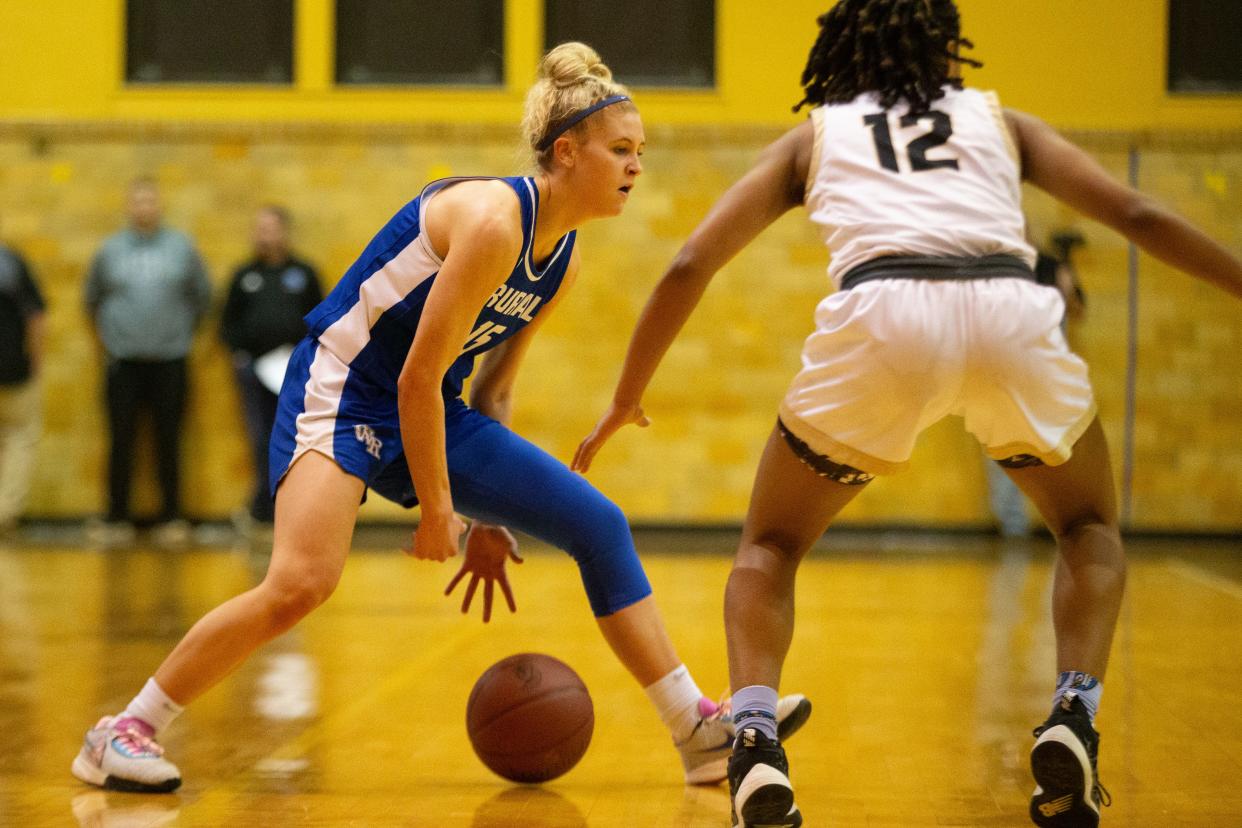 Washburn Rural senior Zoe Canfield (15) dribbles against Topeka High sophomore Keimara Marshall (12) in the second half of the game Tuesday, Feb. 13, 2024, inside Topeka High School.