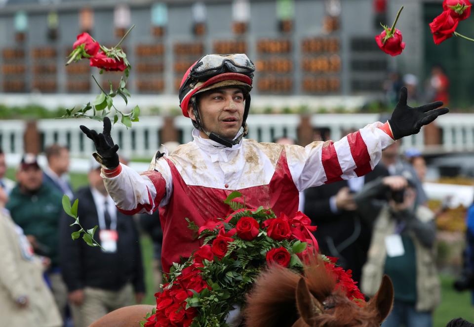 Jockey Sonny Leon tossed roses in the winners circle from the Garland of Roses after he rode Rich Strike to the 148th Kentucky Derby at Churchill Downs in Louisville, Ky. on May 7, 2022.  