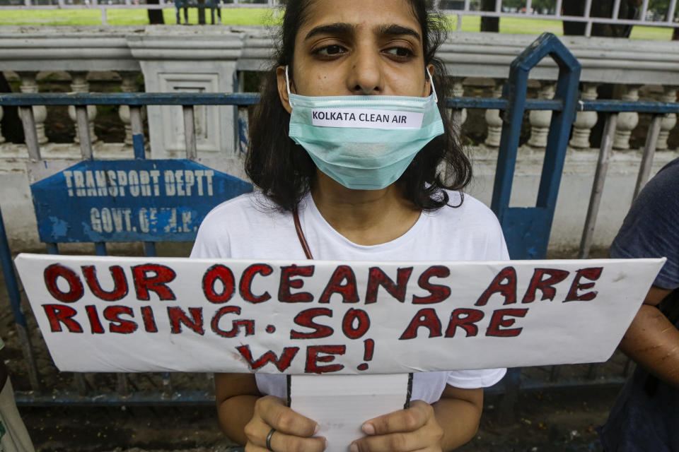 A protestor holds a placard and participates in a demonstration in Kolkata, India, Friday, Sept. 20, 2019. The protestors gathered in response to a day of worldwide demonstrations calling for action to guard against climate change began ahead a U.N. summit in New York. (AP Photo/Bikas Das)
