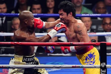 May 2, 2015; Las Vegas, NV, USA; Floyd Mayweather and Manny Pacquiao box during their world welterweight championship bout at MGM Grand Garden Arena. Mandatory Credit: Joe Camporeale-USA TODAY Sports