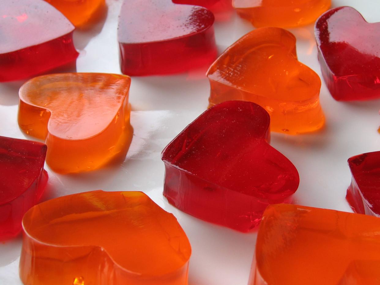 red and orange heart shaped jello displayed on a white plate