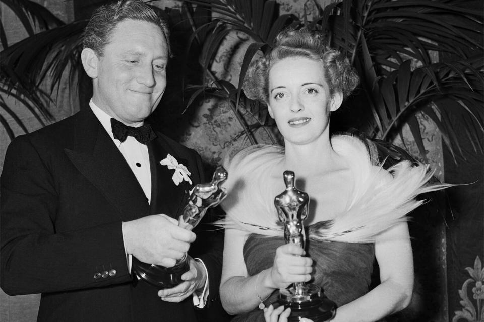 (Original Caption) Hollywood, Calif.: Spencer Tracy and Bette Davis shown with their trophies for the Best Motion Picture of 1938 at recent Morton's Academy Awards Dinner. Miss Davis won for her performance in Jezebel and Mr. Tracy for his acting in Boys Town.
