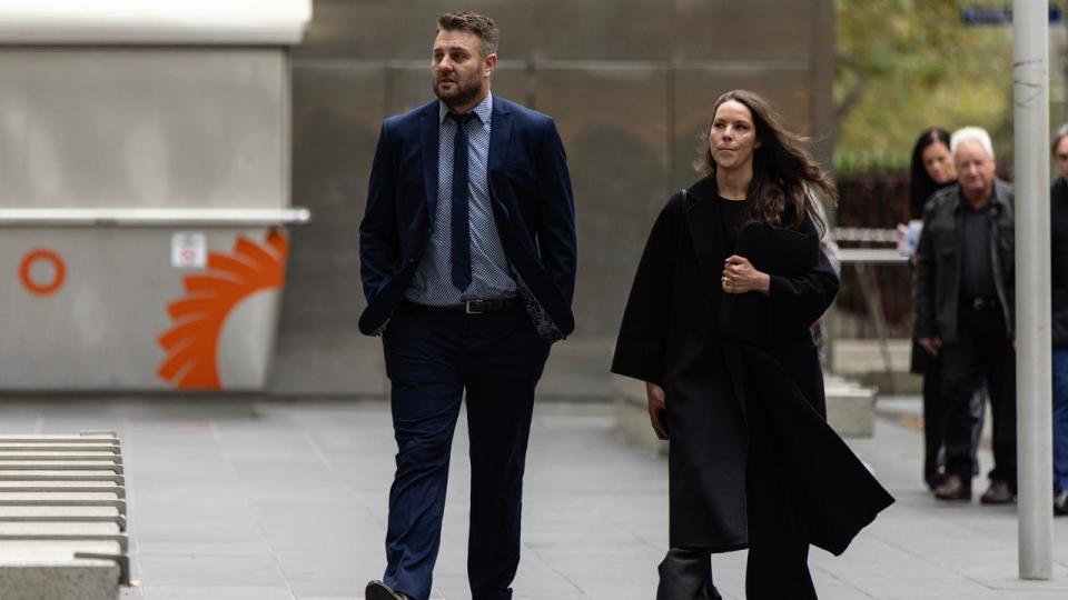 Sam Fisher (left) arrives at the County Court of Victoria