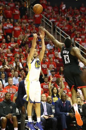 May 14, 2018; Houston, TX, USA; Golden State Warriors guard Klay Thompson (11) shoots over Houston Rockets guard James Harden (13) during the fourth quarter in game one of the Western conference finals of the 2018 NBA Playoffs at Toyota Center. Mandatory Credit: Troy Taormina-USA TODAY Sports