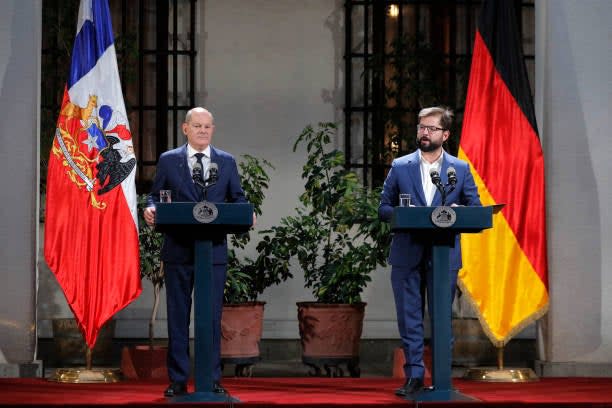 Chile’s president Gabriel Boric speaks next to Germany’s chancellor Olaf Scholz during a joint statement following their meeting at La Moneda presidential palace in Santiago, on 29 January 2023 (AFP via Getty Images)