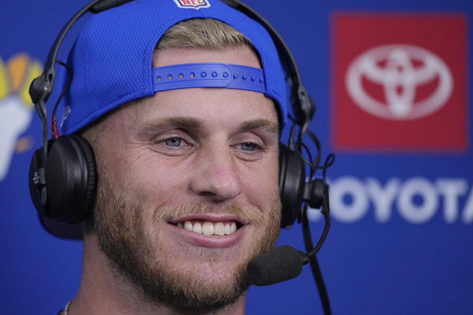 Los Angeles Rams wide receiver Cooper Kupp smiles as he conducts an interview during the first half of a preseason NFL football game against the Las Vegas Raiders Saturday, Aug. 19, 2023, in Inglewood, Calif. (AP Photo/Mark J. Terrill)