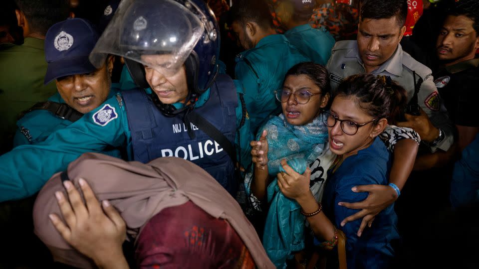 Firefighters rescue people from the deadly blaze on February 29, 2024. - Mohammad Ponir Hossain/Reuters