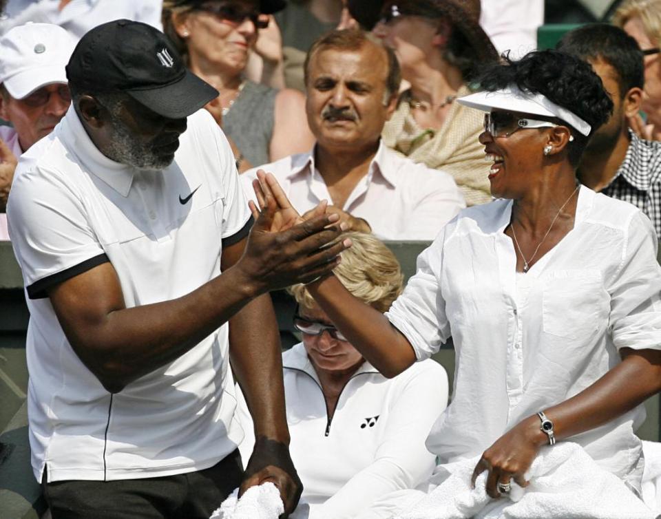 Richard Williams celebrates with partner Lakeisha after Serena beat Russia’s Elena Dementieva 6-7, 7-6, 8-6 during a Women’s Semi-Final match in the 2009 Wimbledon Tennis Championships at the All England Tennis Club. AFP via Getty Images