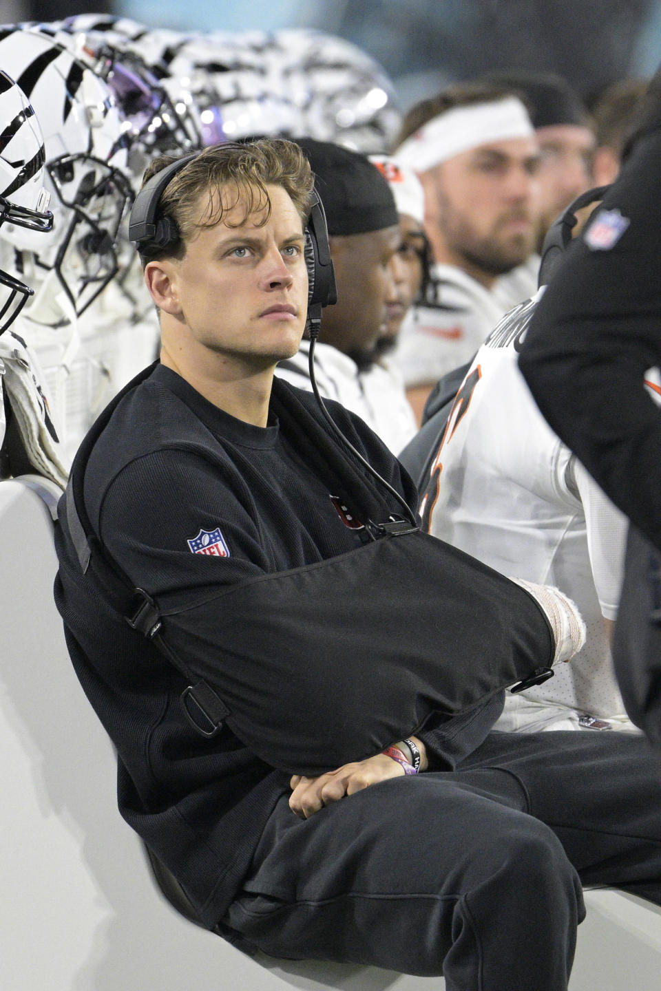 Injured Cincinnati Bengals quarterback Joe Burrow watches from the sidelines during the first half of an NFL football game against the Jacksonville Jaguars, Monday, Dec. 4, 2023, in Jacksonville, Fla. (AP Photo/Phelan M. Ebenhack)