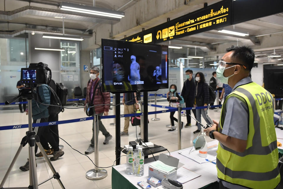 FILE - In this Jan. 29, 2020, file photo provided by Thai Government Spokesmen's office, a health worker watches thermal images monitoring arriving passengers at Suvarnabhumi International airport to help detect passengers who may be infected with new coronavirus virus in Bangkok, Thailand. Throughout January, the World Health Organization publicly praised China for what it called a speedy response to the new coronavirus. It repeatedly thanked the Chinese government for sharing the genetic map of the virus “immediately” and said its work and commitment to transparency were “very impressive, and beyond words.” But behind the scenes, there were significant delays by China and considerable frustration among WHO officials over the lack of outbreak data, The Associated Press has found. (Thai Government Spokesman's office via AP, File)