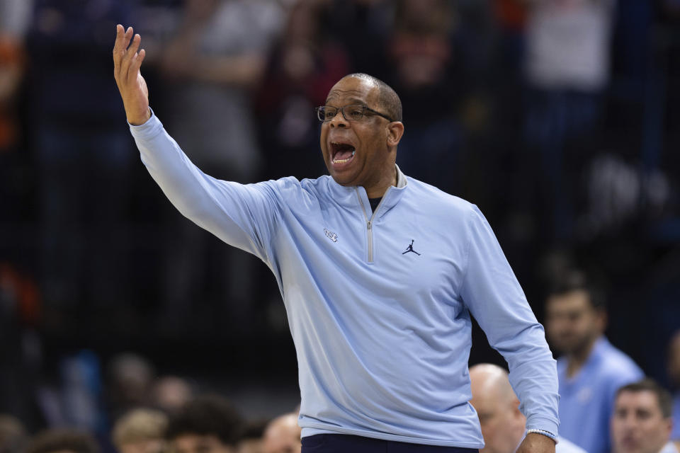 North Carolina head coach Hubert Davis gestures to his team during the first half of an NCAA college basketball game against Virginia in Charlottesville, Va., Tuesday, Jan. 10, 2023. (AP Photo/Mike Kropf)