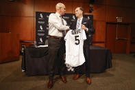 New Chicago White Sox baseball team manager Pedro Grifol, left, is given a Chicago White Sox jersey by team general manager and senior vice president Rick Hahn, right, during news conference, Thursday, Nov. 3, 2022, in Chicago. (AP Photo/Kamil Krzaczynski)