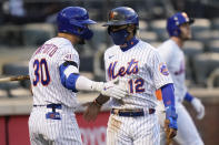 New York Mets' Francisco Lindor (12) celebrates with Michael Conforto (30) after scoring on a single by Pete Alonso during the eighth inning of a baseball game against the Philadelphia Phillies as Jeff McNeil (6) walks away in the first game of a doubleheader Tuesday, April 13, 2021, in New York. The Mets won 4-3. (AP Photo/Frank Franklin II)