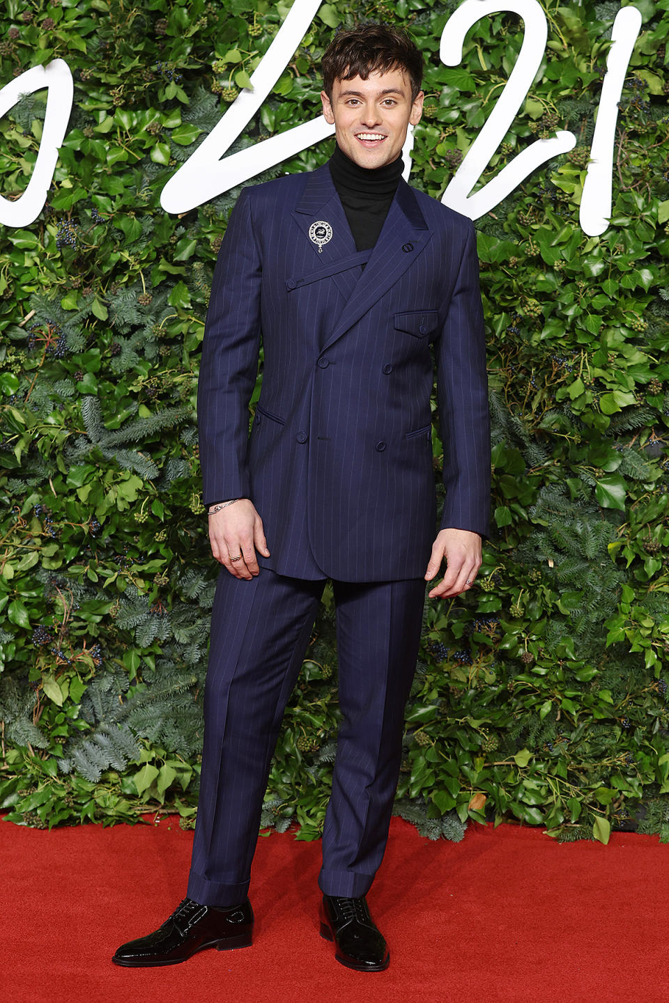 <p>in a pinstripe Christian Dior suit. </p>