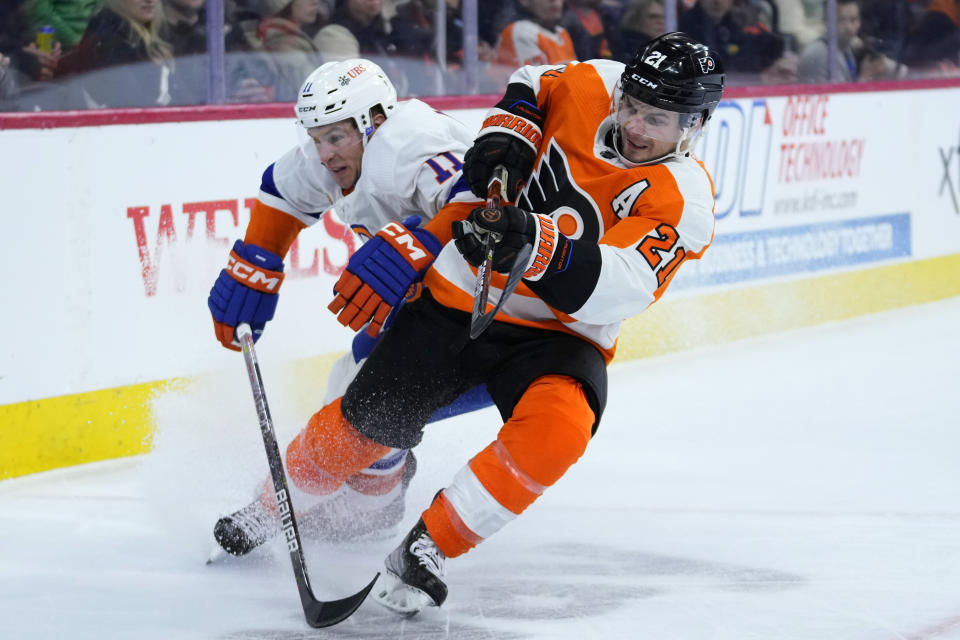 New York Islanders' Zach Parise, left, and Philadelphia Flyers' Scott Laughton collide during the first period of an NHL hockey game, Monday, Feb. 6, 2023, in Philadelphia. (AP Photo/Matt Slocum)