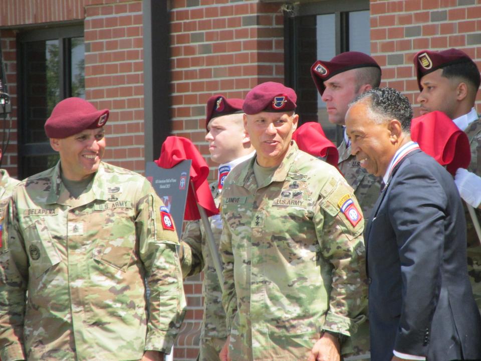 Retired Gen. Dennis Via, far right, is congratulated by  Maj. Gen. Christopher LaNeve, second from right, and Command Sgt. Maj. Randolph Delapena, after being inducted into the 82nd Airborne Division Hall of Fame during a ceremony Wednesday, May 24, 2023, at Fort Bragg.