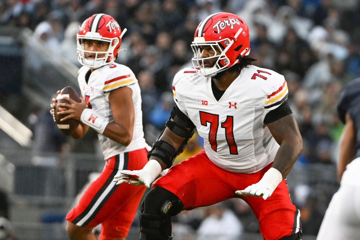 Maryland offensive lineman Jaelyn Duncan (71) looks to block for Maryland quarterback Taulia Tagovailoa (3) against Penn State during the first half of an NCAA college football game, Saturday, Nov. 12, 2022, in State College, Pa. (AP Photo/Barry Reeger)