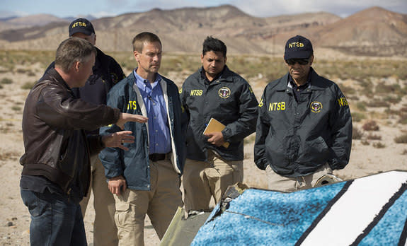 Virgin Galactic pilot Todd Ericson shares information at the SpaceShipTwo accident site with National Transportation Safety Board (NTSB) officials. The first SpaceShipTwo broke apart and crashed during rocket-powered test flight over the Mojave