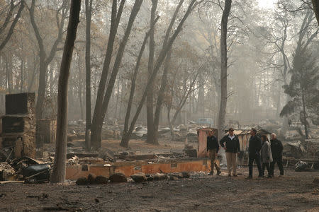 U.S. President Donald Trump visits the charred wreckage of Skyway Villa Mobile Home and RV Park with FEMA head Brock Long (L), Governor-elect Gavin Newsom (3rd R), Paradise Mayor Jody Jones (2nd R) and Governor Jerry Brown in Paradise, California, U.S., November 17, 2018. REUTERS/Leah Millis