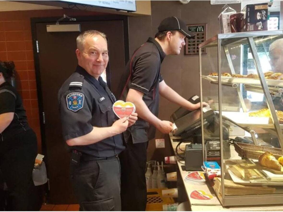 Assistant Fire Chief Lance Caven is pictured at the Millstream McDonald's for McHappy Days in 2017, raising money for Jeneece Place — where children and their families can stay while receiving medical care in Victoria — and Ronald McDonald House. (Langford Fire Rescue Facebook - image credit)