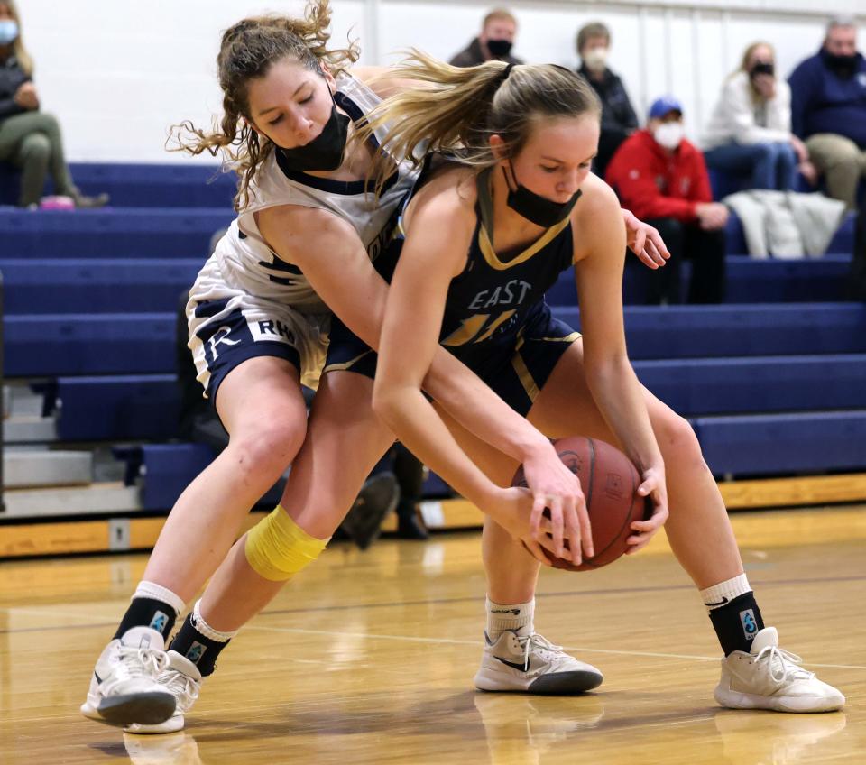 Rockland defender Julia Elie goes after the basketball held by East Bridgewater's Allie Pechulis,  during a game on Tuesday, Jan. 18, 2022.