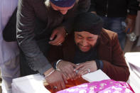 Afghan Sikh men mourn their beloved ones during a funeral procession for those who were killed on Wednesday by a lone Islamic State gunman, rampaged through a Sikh house of worship, in Kabul, Afghanistan, Thursday, March 26, 2020. An explosive device disrupted Thursday's funeral service for 25 members of Afghanistan's Sikh minority community, killed in an attack by the Islamic State group on their house of worship in the heart of the capital. (AP Photo/Tamana Sarwary)