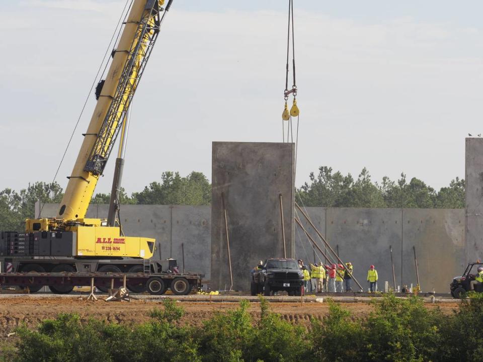 A crane lifts the precast concrete walls of the the Buc-ee’s travel center under construction along I-10 near Gulfport, MS. Until now, the work has been foundation and utility work that is less visible for travelers on the interstate.