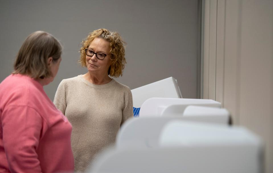 Poll worker Margie Schellhase, right, talks to Debbie Deutsch of Evansville, Ind., about the voting process during in-person early voting at Old National Events Plaza in Evansville, Ind., Thursday afternoon, April 28, 2022. Since the 2020 general election, Vanderburgh County has used state-mandated voter-verified paper trail voting machines.