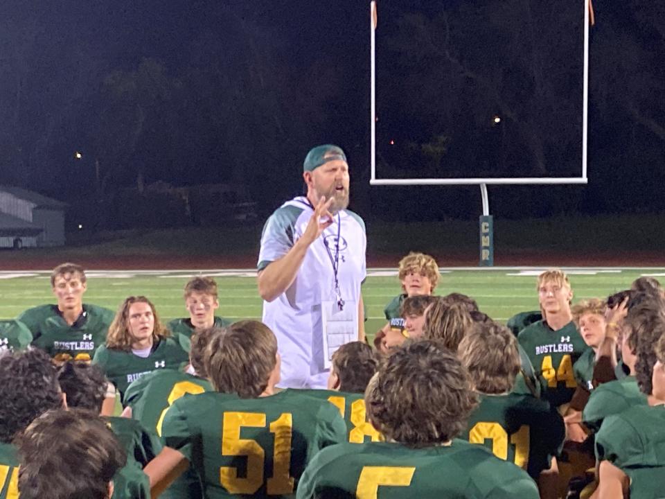 C.M. Russell High head coach Dennis Morris speaks to the team following a victory over Kalispell Flathead in August.