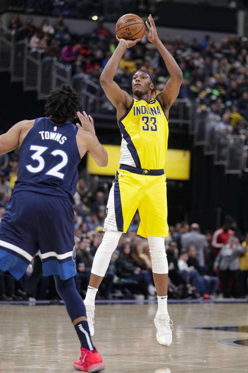Indiana Pacers center Myles Turner (33) shoots over Minnesota Timberwolves center Karl-Anthony Towns (32) during the second half of an NBA basketball game in Indianapolis, Friday, Jan. 17, 2020. The Pacers won 116-114. (AP Photo/Michael Conroy)