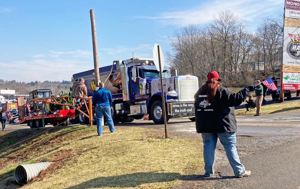 Supporters cheer The People's Convoy as it leaves Hagerstown Speedway on Thursday morning for a lap around the D.C. Beltway.