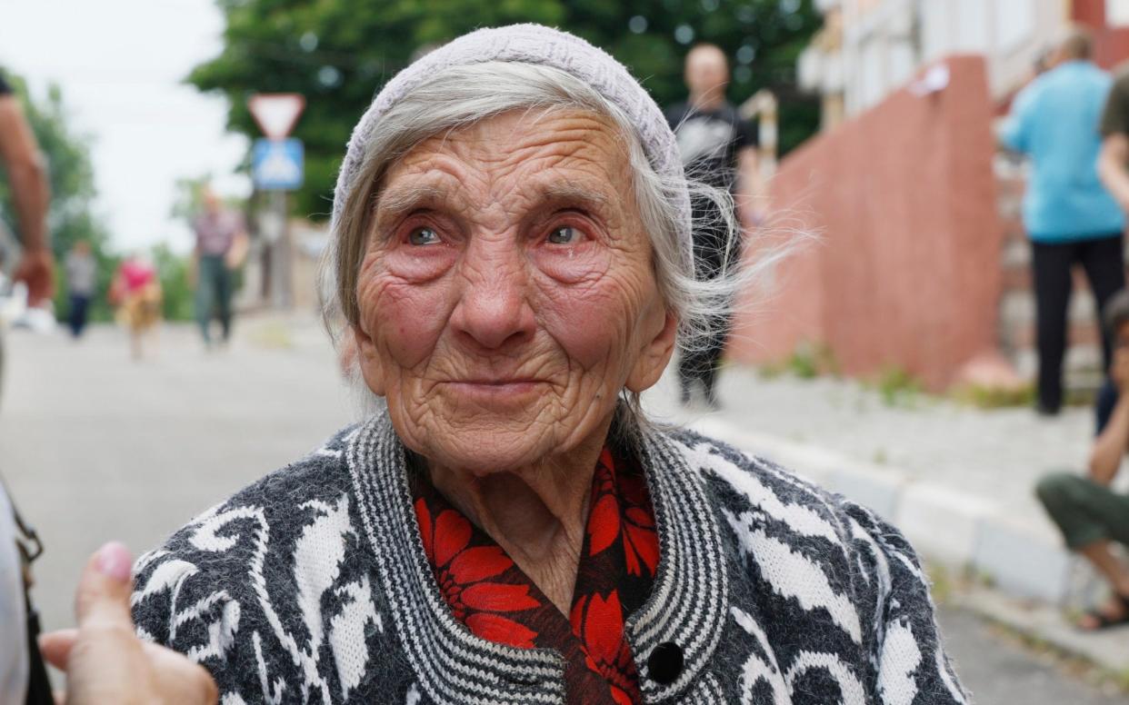 An elderly woman cries, because she can't find her dog on June 8, 2023 in Kherson, Ukraine - Getty Images